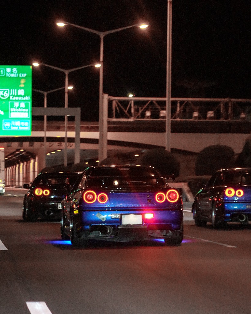 Nissan Skyline GT-Rs cruising at night