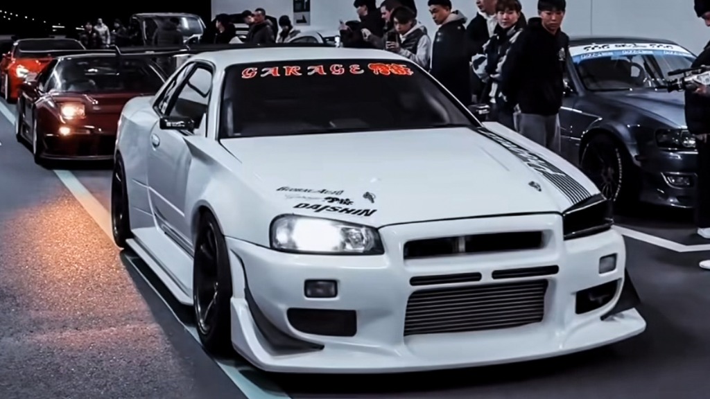 Sports cars gathering at night in Tokyo Bay